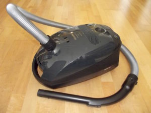 A black Miele canister packed with healthy and efficient features.